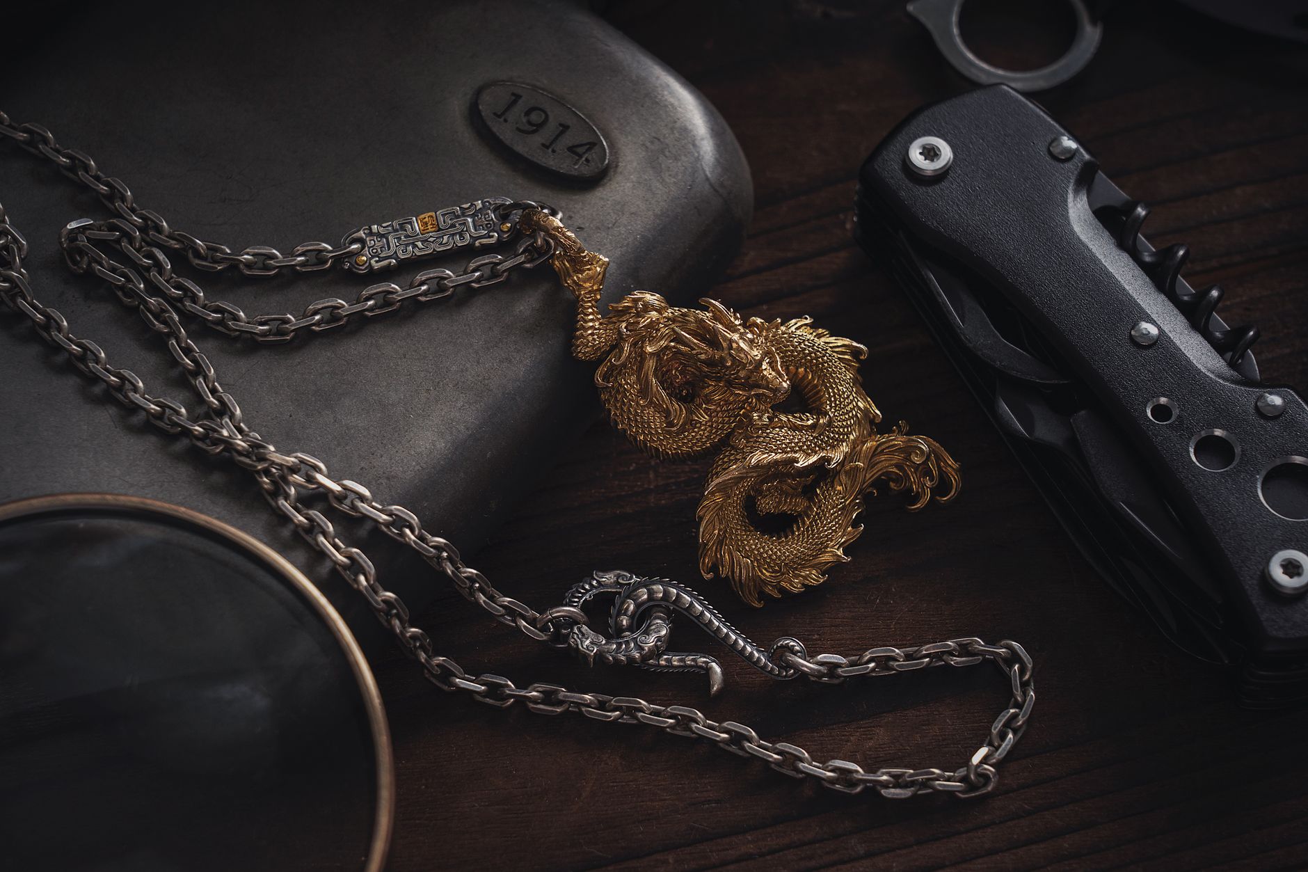 Pendentif et chaîne en métal vieilli posés à plat